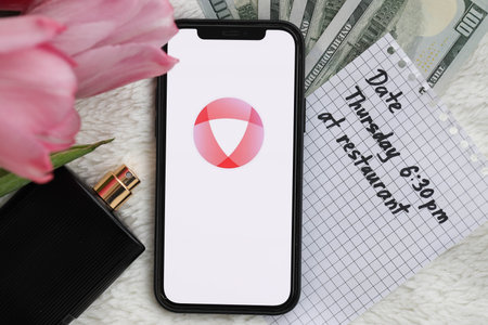 KYIV, UKRAINE - FEBRUARY 23, 2024 Open logo of famous dating website or app on iPhone display screen close upのeditorial素材