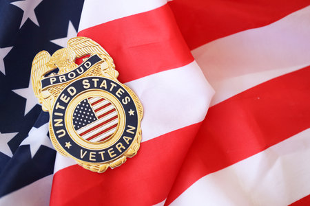 KYIV, UKRAINE - MARCH 9, 2024 US Proud Veteran badge on United States of America flag close upのeditorial素材