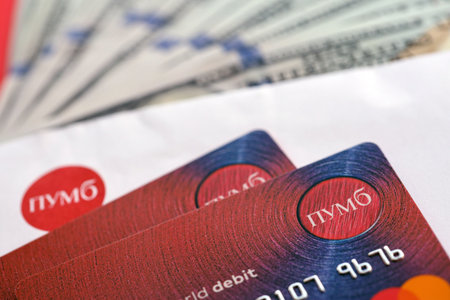 TERNOPIL, UKRAINE - JULY 7, 2023 Bank Card of PUMB Ukrainian Bank FUIB with red logo close up