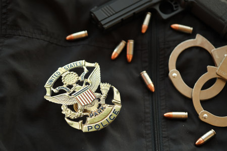 KYIV, UKRAINE - MARCH 9, 2024 US United States Park Police badge on black jacket uniform with gun, bullets and handcuffs close upのeditorial素材