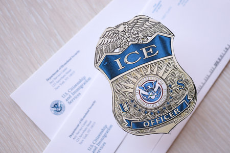 KYIV, UKRAINE - MARCH 9, 2024 US ICE Officer badge on USCIS mail envelope close upのeditorial素材