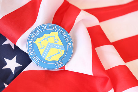 KYIV, UKRAINE - MARCH 9, 2024 US The Department of the Treasury seal on United States of America flag close upのeditorial素材