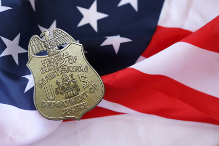 KYIV, UKRAINE - MARCH 9, 2024 US FBI Federal Bureau of Investigation badge on United States of America flag close upのeditorial素材