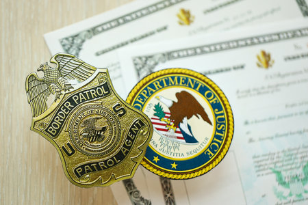 KYIV, UKRAINE - MARCH 9, 2024 US Border Patrol Agent badge and Department of Justice seal on United States Certificate of Naturalization close upのeditorial素材