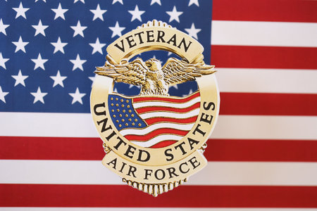 KYIV, UKRAINE - MARCH 9, 2024 US Air Force Veteran badge on United States of America flag close upのeditorial素材