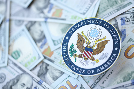 KYIV, UKRAINE - MARCH 9, 2024 US Department of State seal on many US hundred dollar bills close up