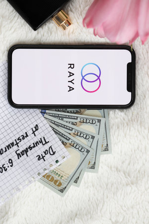 KYIV, UKRAINE - FEBRUARY 23, 2024 Raya logo of famous dating website or app on iPhone display screen close upのeditorial素材
