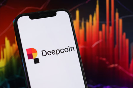 KYIV, UKRAINE - MARCH 15, 2024 Deepcoin logo on iPhone display screen and crypto currency value charts. Cryptocurrency exchange portalのeditorial素材