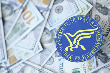 KYIV, UKRAINE - MARCH 9, 2024 US Department of Health and human Services seal on many US hundred dollar bills close upのeditorial素材