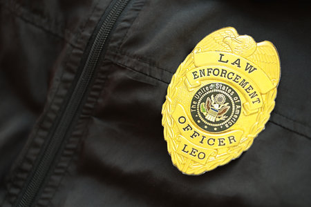 KYIV, UKRAINE - MARCH 9, 2024 US Law Enforcement Officer badge on black jacket uniform close up