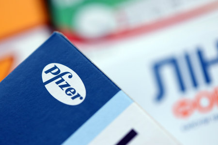 KYIV, UKRAINE - NOVEMBER 27, 2023 Pfizer logo on cardboard pill box in drug store close upのeditorial素材