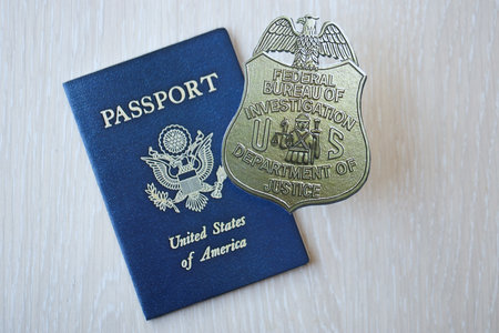KYIV, UKRAINE - MARCH 9, 2024 US FBI Federal Bureau of Investigation badge and United States passport on wooden table close upのeditorial素材