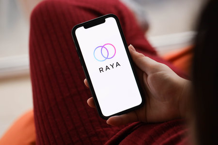 KYIV, UKRAINE - FEBRUARY 23, 2024 Raya logo of famous dating website or app on iPhone display screen close upのeditorial素材