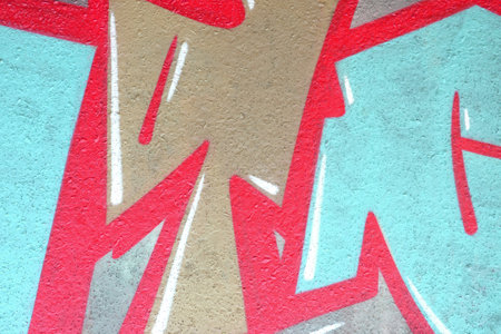 Colorful background of graffiti painting artwork with bright aerosol outlines on wall. Old school...