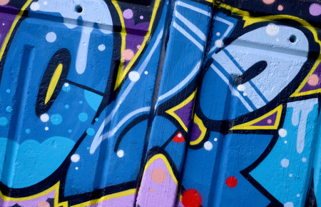 Colorful background of graffiti painting artwork with bright aerosol outlines on wall. Old school...