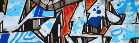 Colorful background of graffiti painting artwork with bright aerosol outlines on wall. Old school...