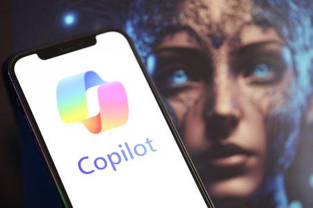 KYIV, UKRAINE - MARCH 17, 2024 Microsoft Copilot logo on iPhone display screen with background of...