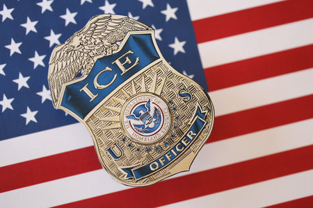 KYIV, UKRAINE - MARCH 9, 2024 US ICE Officer badge on United States of America flag close up