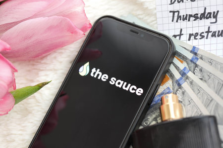 KYIV, UKRAINE - FEBRUARY 23, 2024 The Sauce logo of famous dating website or app on iPhone display screen close upのeditorial素材