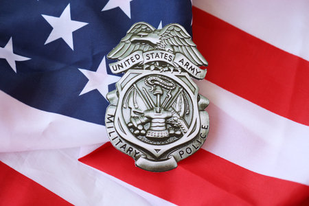 KYIV, UKRAINE - MARCH 9, 2024 US Army Military Police badge on United States of America flag close upのeditorial素材
