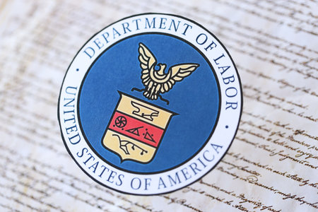 KYIV, UKRAINE - MARCH 9, 2024 US Department of Labor seal on United States Constitution close up