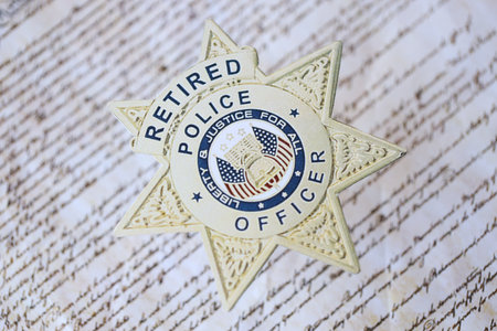 KYIV, UKRAINE - MARCH 9, 2024 US Retired Police Officer badge on United States Constitution close upのeditorial素材