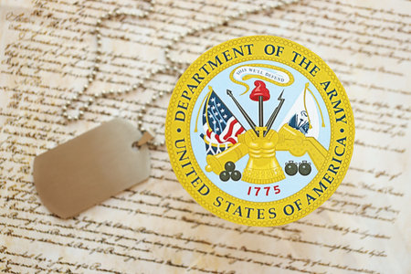 KYIV, UKRAINE - MARCH 9, 2024 US Department of Army seal with dogtags on United States Constitution close upのeditorial素材