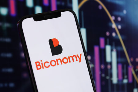 KYIV, UKRAINE - MARCH 15, 2024 Biconomy logo on iPhone display screen and crypto currency value...