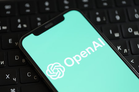 KYIV, UKRAINE - MARCH 17, 2024 OpenAI logo on iPhone display screen and MacBook keyboard. Artificial...