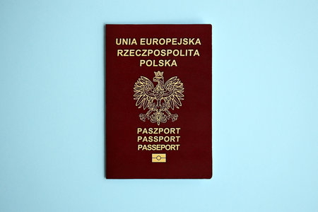 Poland passport on blue background close up. Tourism and citizenship conceptの写真素材