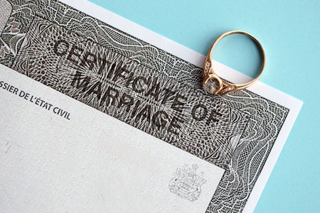 Canadian Certificate of registration of marriage blank document and wedding ring close upの写真素材
