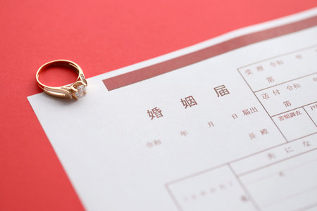 Japanese marriage registration blank document and wedding proposal ring on table close upの写真素材