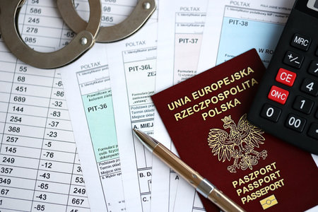 Concept of problems and troubles during tax reporting and taxpaying in poland. Accountant table with polish tax formsの写真素材