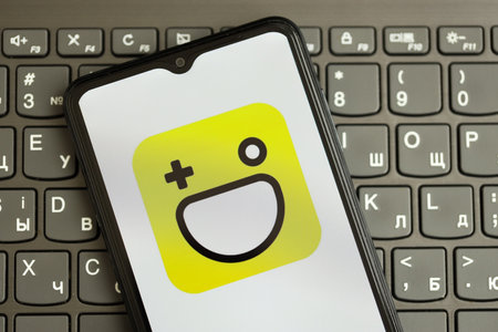 KYIV, UKRAINE - APRIL 1, 2024 Hago icon on smartphone screen on black keyboard close up. iPhone display with app logo on dark keypad buttonsのeditorial素材