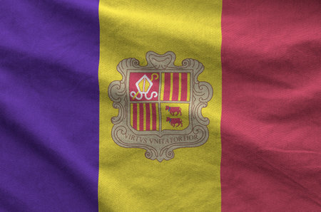 Andorra flag depicted on folded wavy fabric of old cloth close upの写真素材