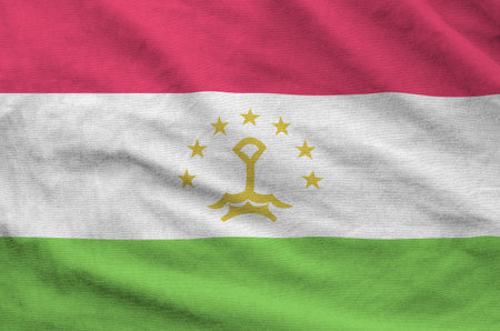 Tajikistan flag depicted on folded wavy fabric of old cloth close upの写真素材