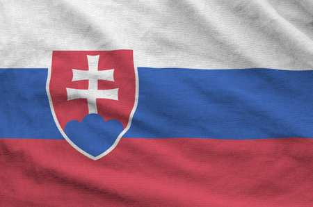 Slovakia flag depicted on folded wavy fabric of old cloth close upの写真素材