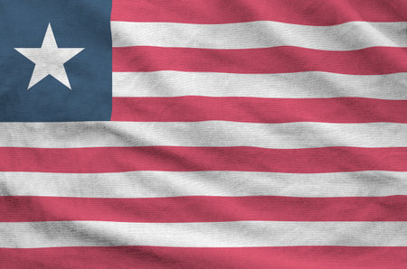 Liberia flag depicted on folded wavy fabric of old cloth close upの写真素材