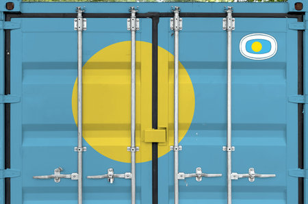 Palau flag depicted on metal doors of shipping cargo container outdoors in docks area close upの写真素材