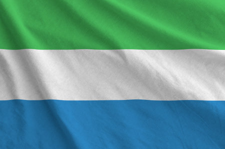 Sierra Leone flag depicted on folded wavy fabric of old cloth close upの写真素材