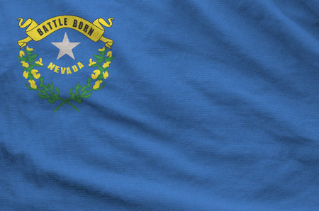 Nevada US state flag depicted on folded wavy fabric of old cloth close upの写真素材