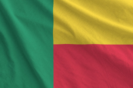 Benin flag depicted on folded wavy fabric of old cloth close upの写真素材