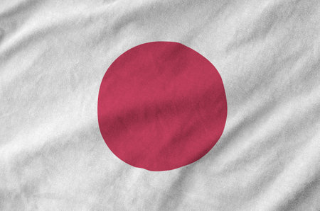 Japan flag depicted on folded wavy fabric of old cloth close upの写真素材
