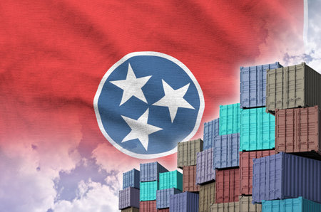 Tennessee US state flag and big stack of shipping cargo containers in docks with sky background close upの写真素材