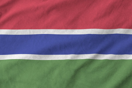 Gambia flag depicted on folded wavy fabric of old cloth close upの写真素材