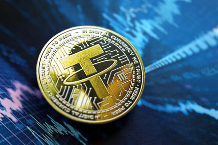 KYIV, UKRAINE - AUGUST 17, 2024 Tether USDT coin on abstract fictional cryptocurrency trading chart in blue color close upのeditorial素材