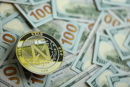 KYIV, UKRAINE - AUGUST 17, 2024 NEAR coin on big amount of hundred US dollar bills close upのeditorial素材