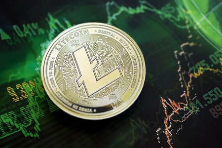 KYIV, UKRAINE - AUGUST 17, 2024 Litecoin LTC coin on dark cryptocurrency digital trading chart in green colors close upのeditorial素材