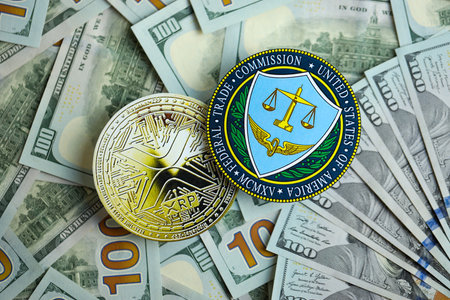 KYIV, UKRAINE - AUGUST 17, 2024 Ripple XRP Coin and US Federal Trade Commission sign on many USD dollar money bills close upのeditorial素材
