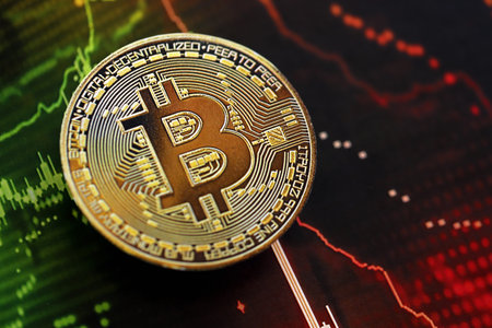 KYIV, UKRAINE - AUGUST 17, 2024 Bitcoin BTC coin on dark cryptocurrency digital trading chart in green and red colors close upのeditorial素材